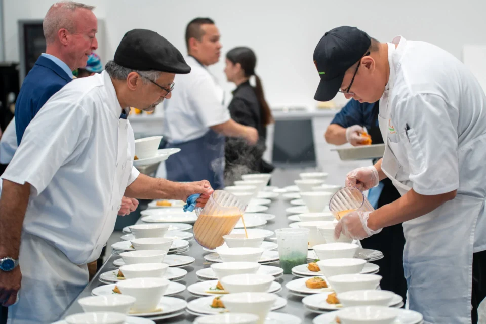 A group of chefs preparing food for a banquet.