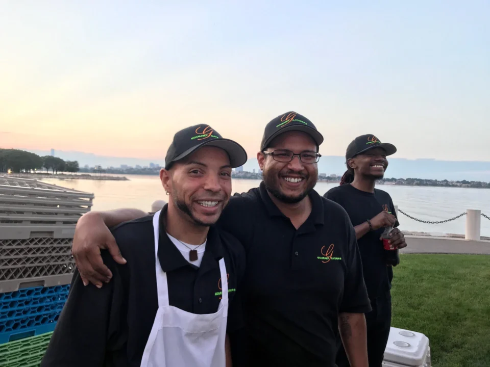 Two men in black shirts and hats standing next to each other.